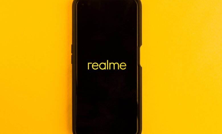 in this photo illustration the realme logo seen displayed on a smartphone and on the background